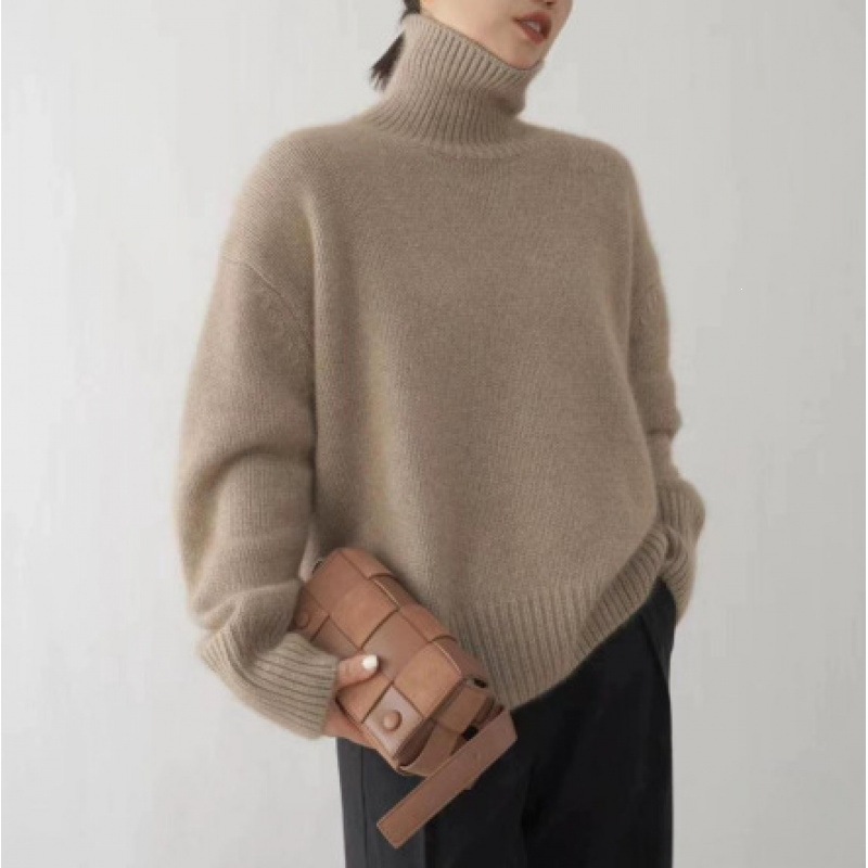 Loose women's knitted sweater with a roll neck