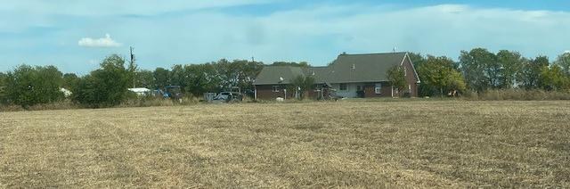 Open agricultural land with the residence in the distance