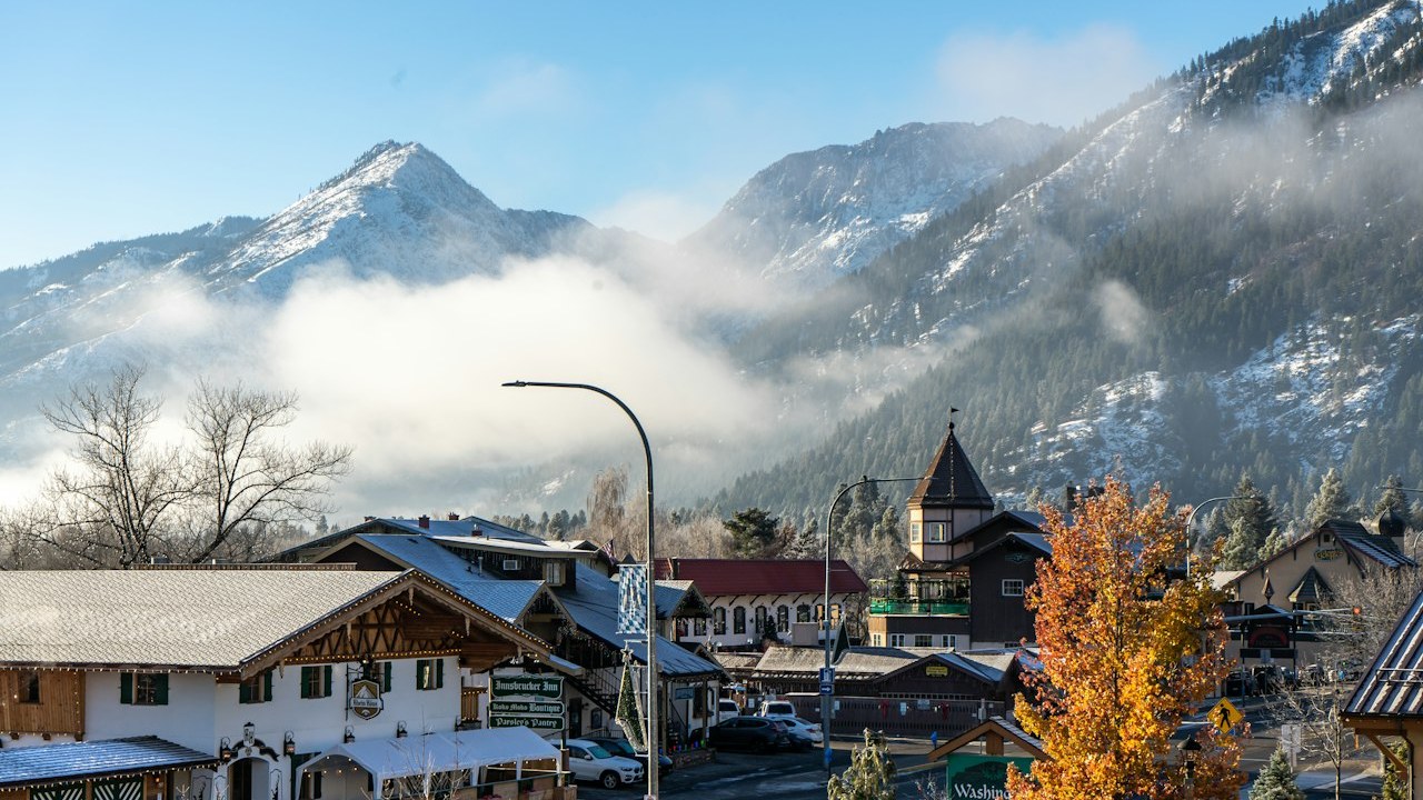 Traditional Bavarian-style timbered chalets in Leavenworth with snow-dusted Cascade mountains rising behind