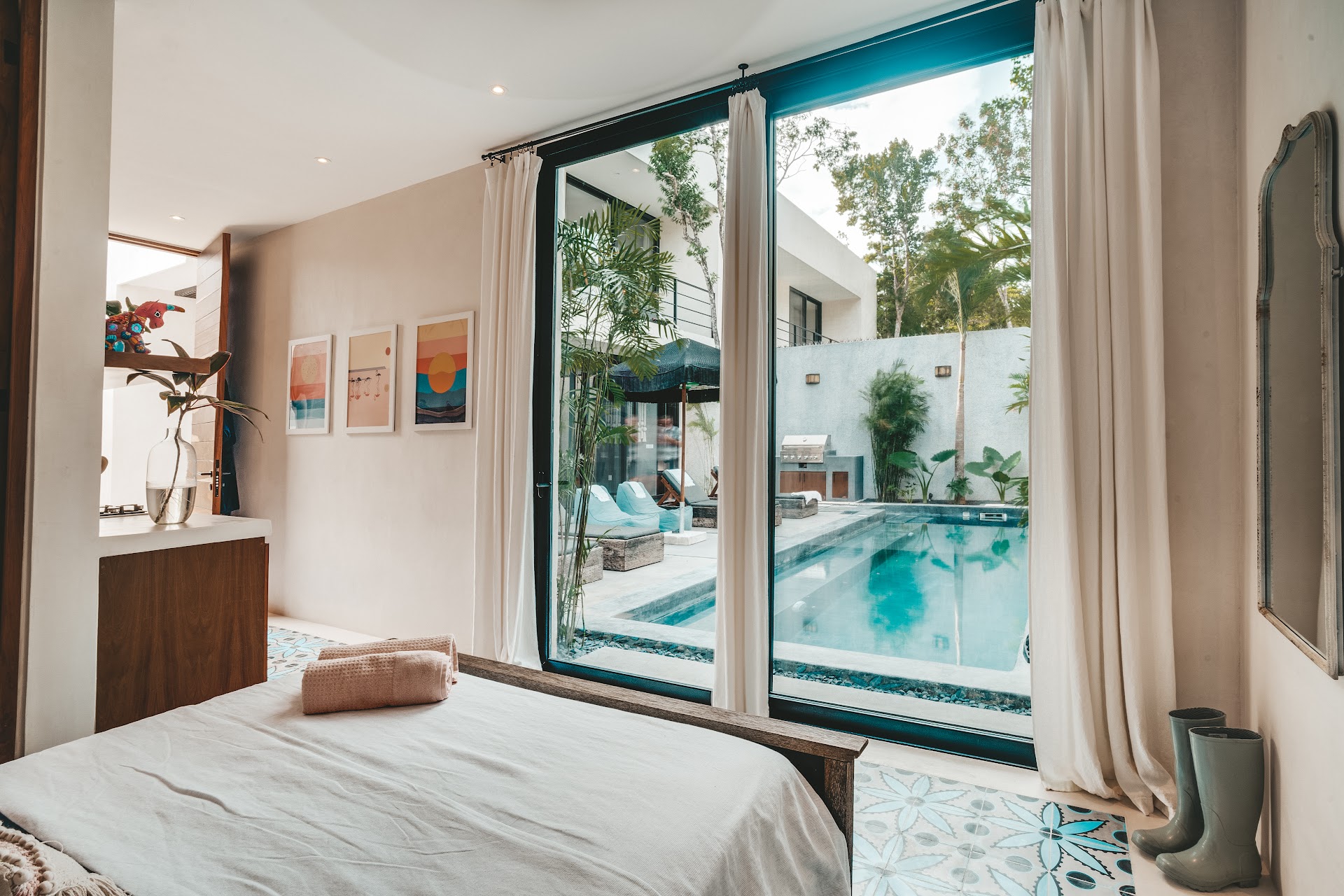 Bedroom opening straight onto the private pool of a Habitat home in Tulum