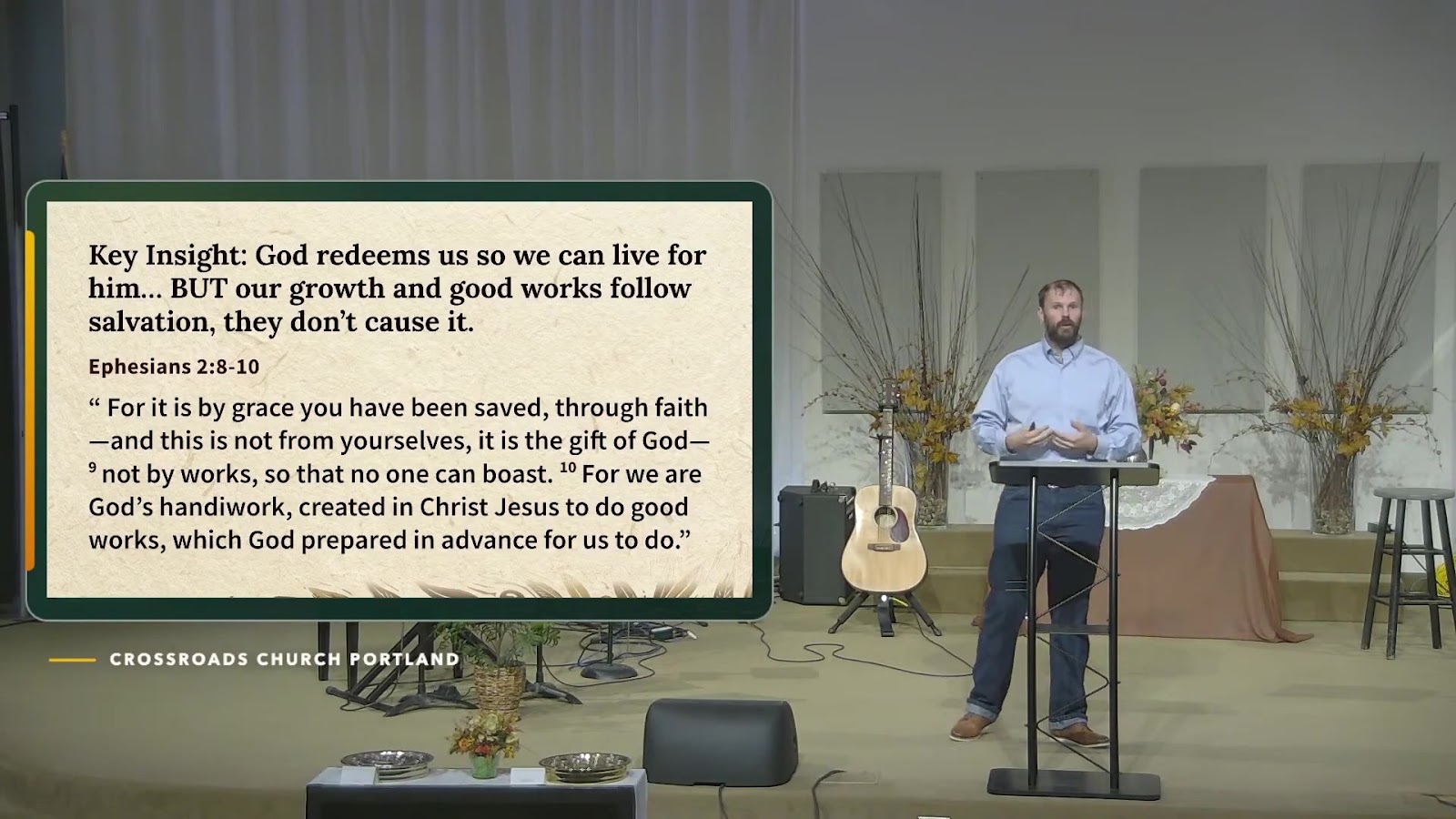 The speaker teaching during Crossroads’ September 27 service beside the message’s grace-and-faith key insight.