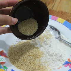 Trứng gà đánh tan, cho 10g bột năng vào đánh chung. Trộn đều bột mì, 40g bột năng và 30g mè trắng với nhau trong đĩa.