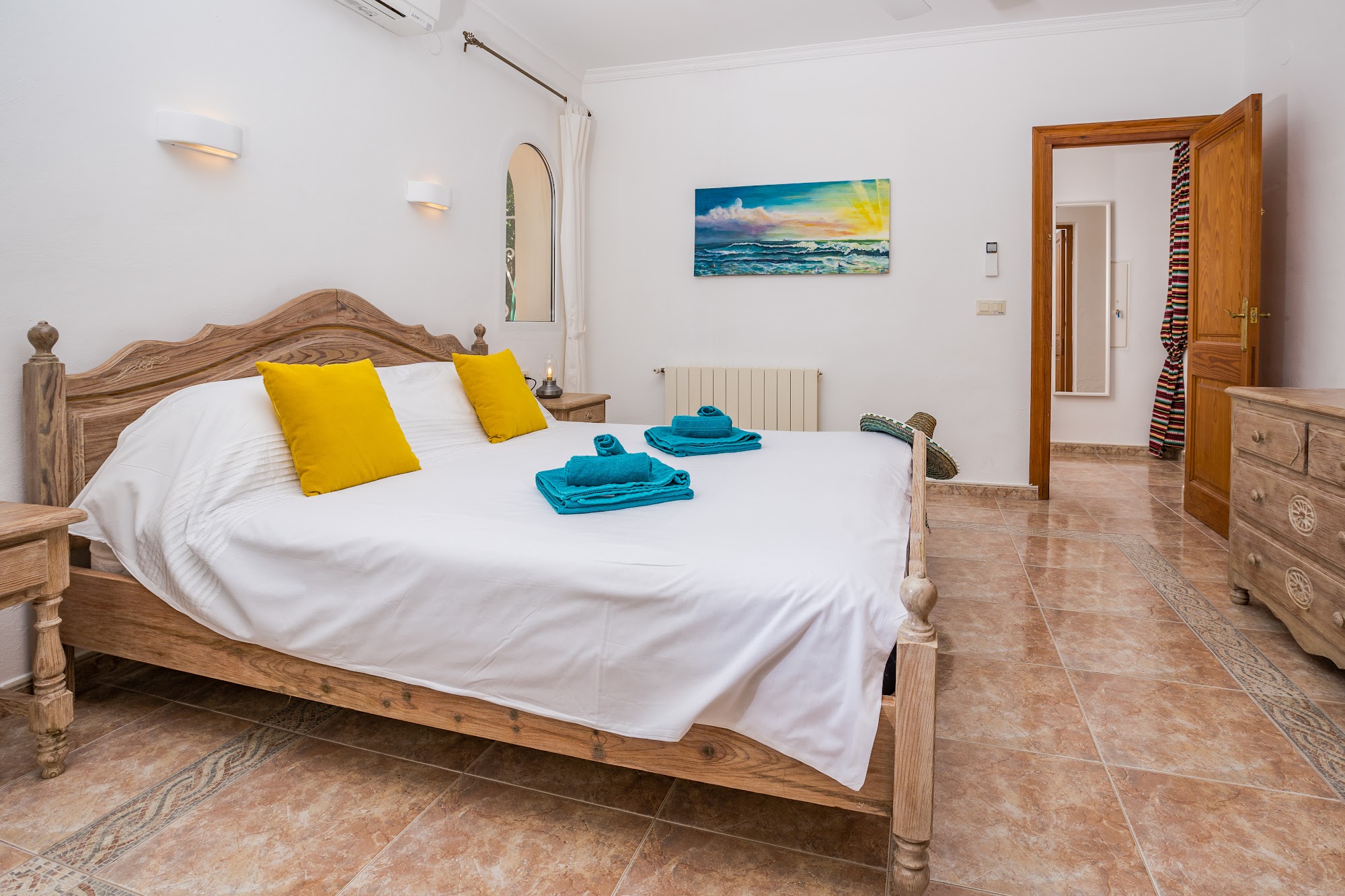 Double bedroom with sea-themed artwork