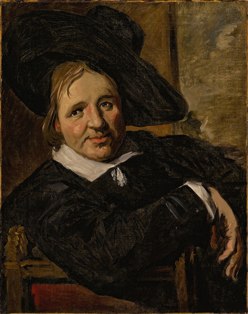 Portrait of a man seated and wearing a hat