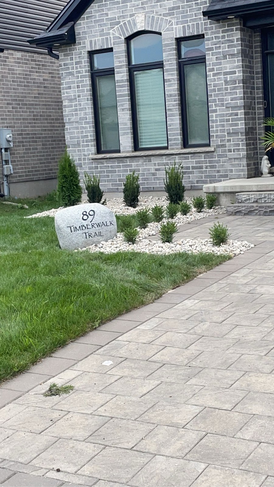 Interlocking stone retaining wall and garden border in London, Ontario
