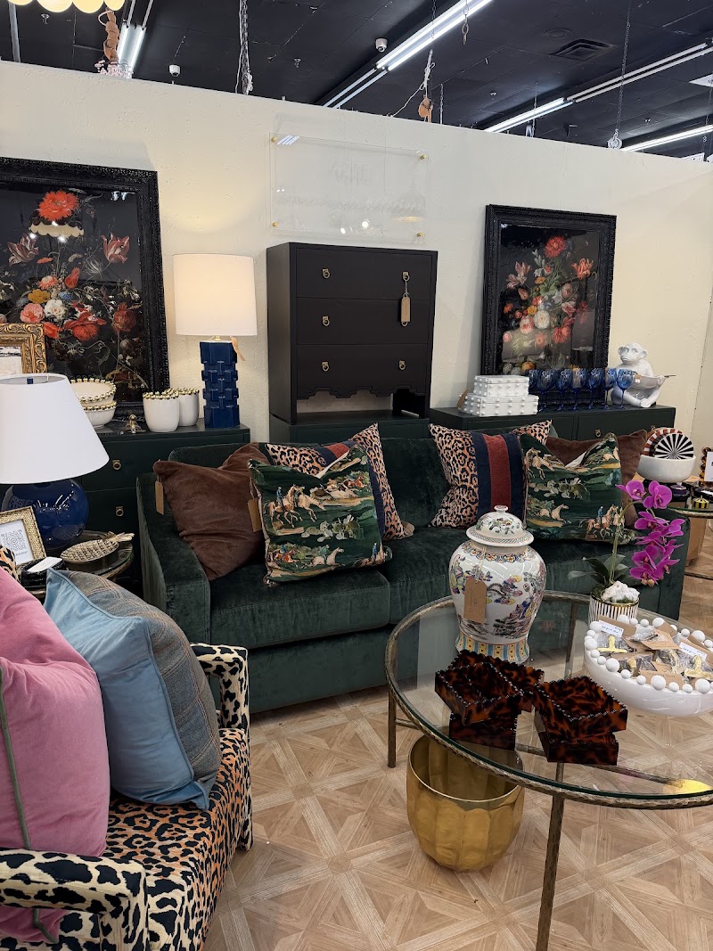 Emerald green velvet sofa with leopard and hunt-scene pillows in the Garner House booth