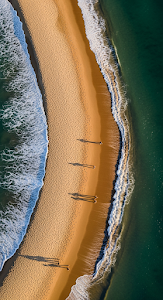 Overhead Aerial View of Beach Shoreline with Long Shadows at Sunset