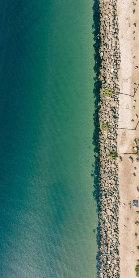 Aerial View Of Rocky Shoreline 2K iPhone Phone Wallpaper