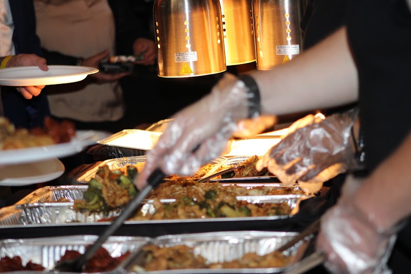 Guests being served at a General Tso's catered event