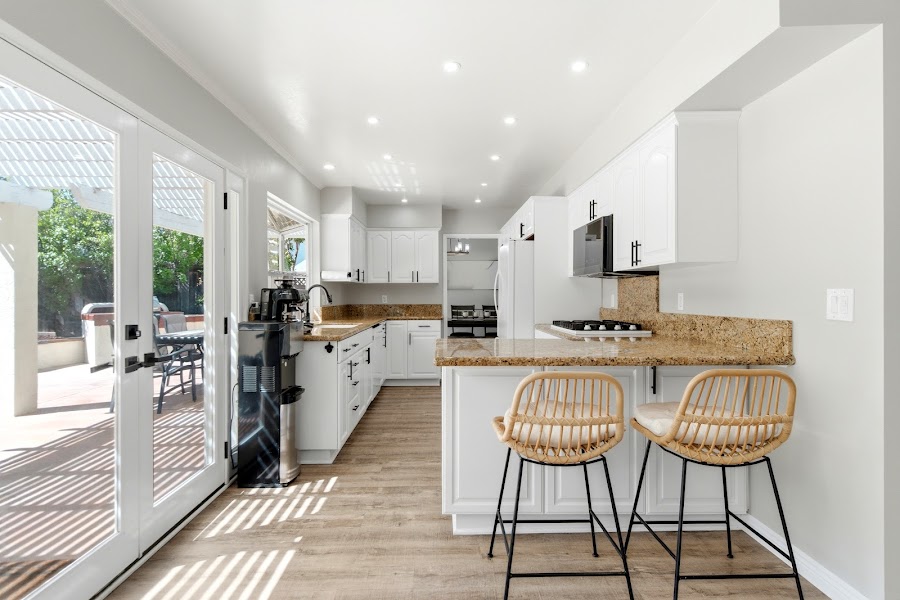 Kitchen breakfast bar with French doors to backyard