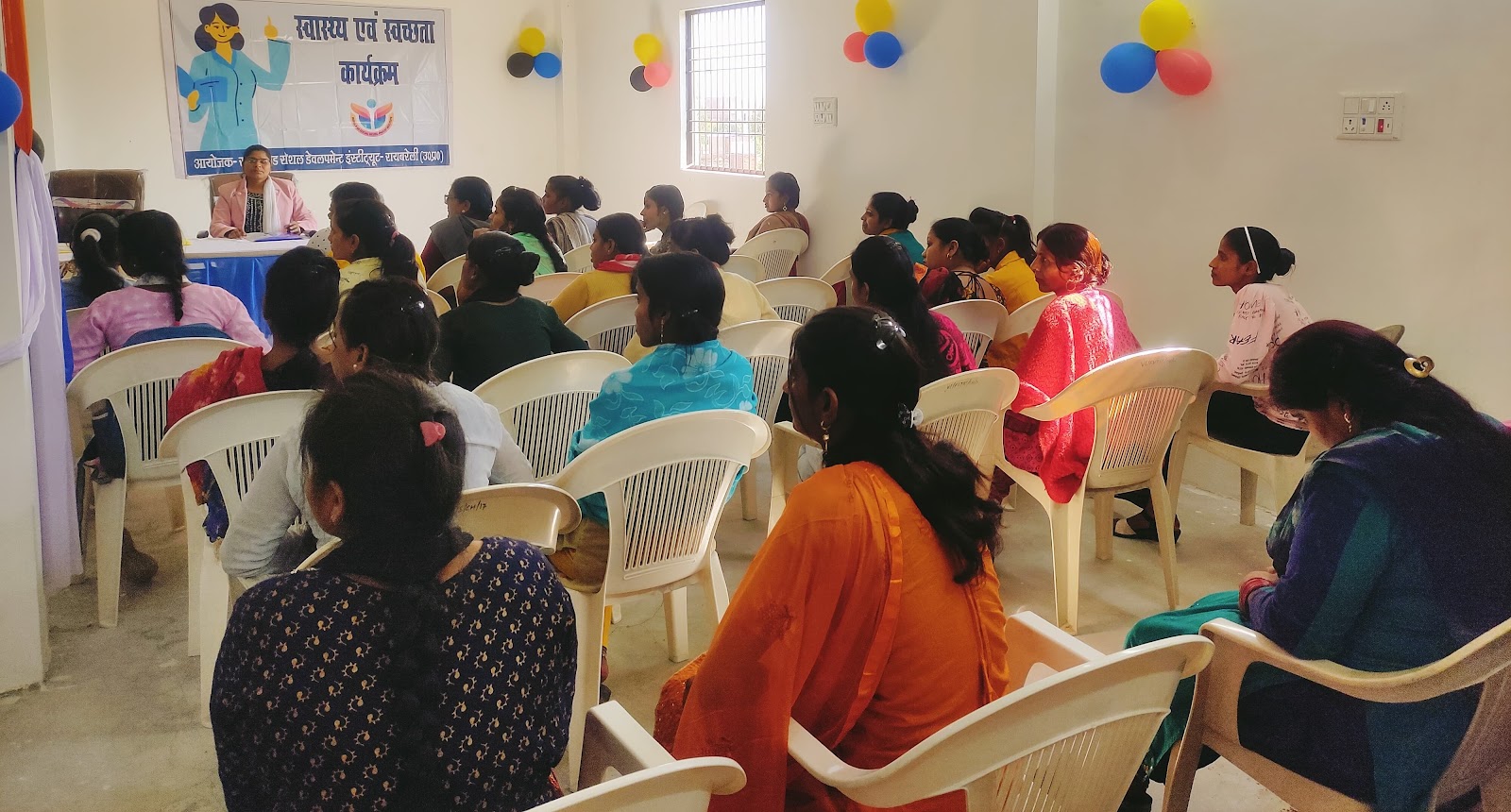 Women attending a community health and sanitation awareness programme
