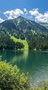 Emerald Mountain Lake Beneath Towering Alpine Peak