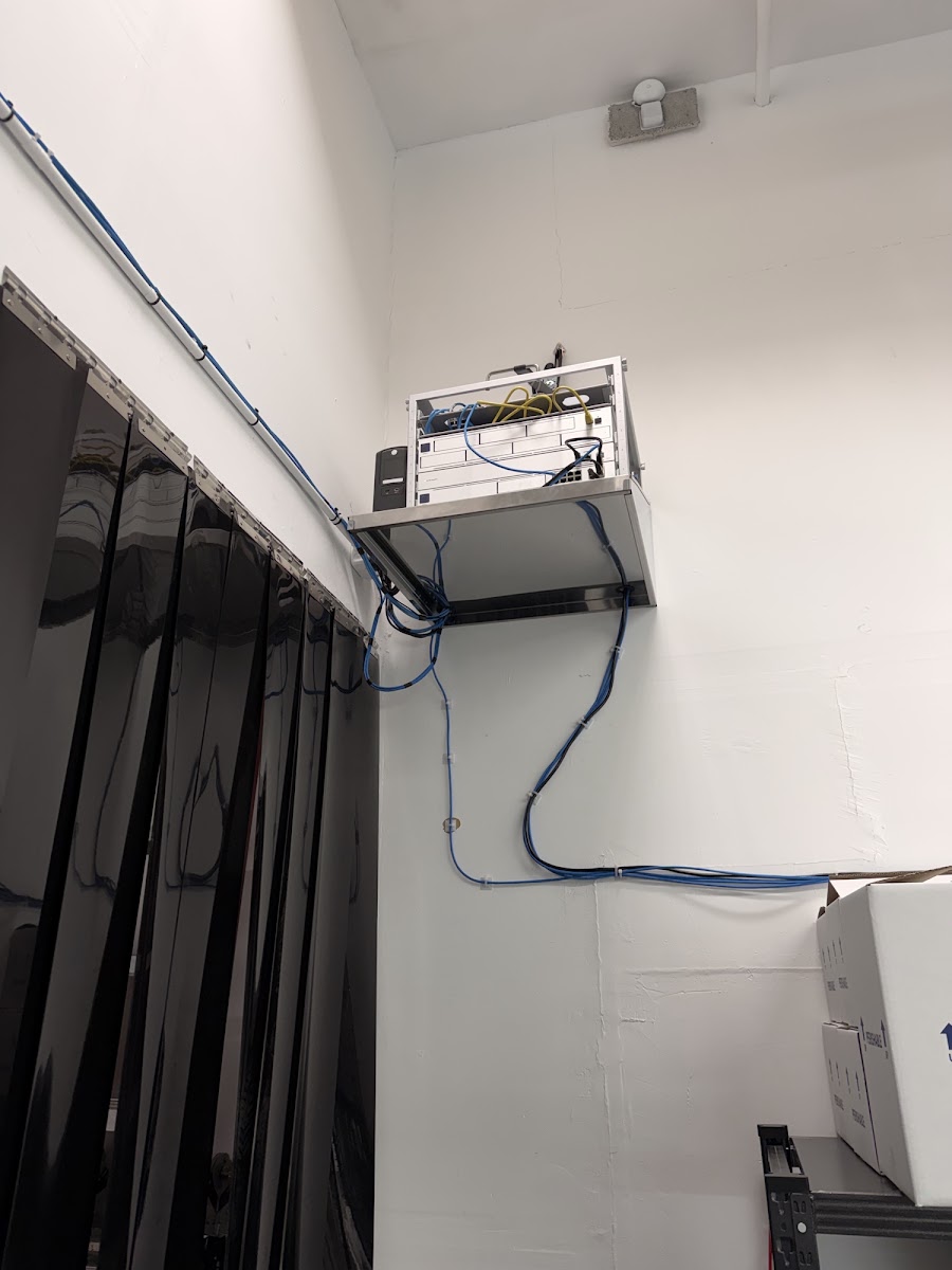 Enterprise network rack mounted in ceiling corner