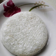 Lót 1 miếng nylon vào chén, cho 1/4 chén cơm vào và nén chặt cơm lại. Cứ để như vậy một lúc khoảng 10 phút cho cơm nguội, sau đó túm nylon cơm để vào đĩa, lật ngược lại là được 1/2 nắp bánh hamburger. Làm tương tự với những chiếc tiếp theo.