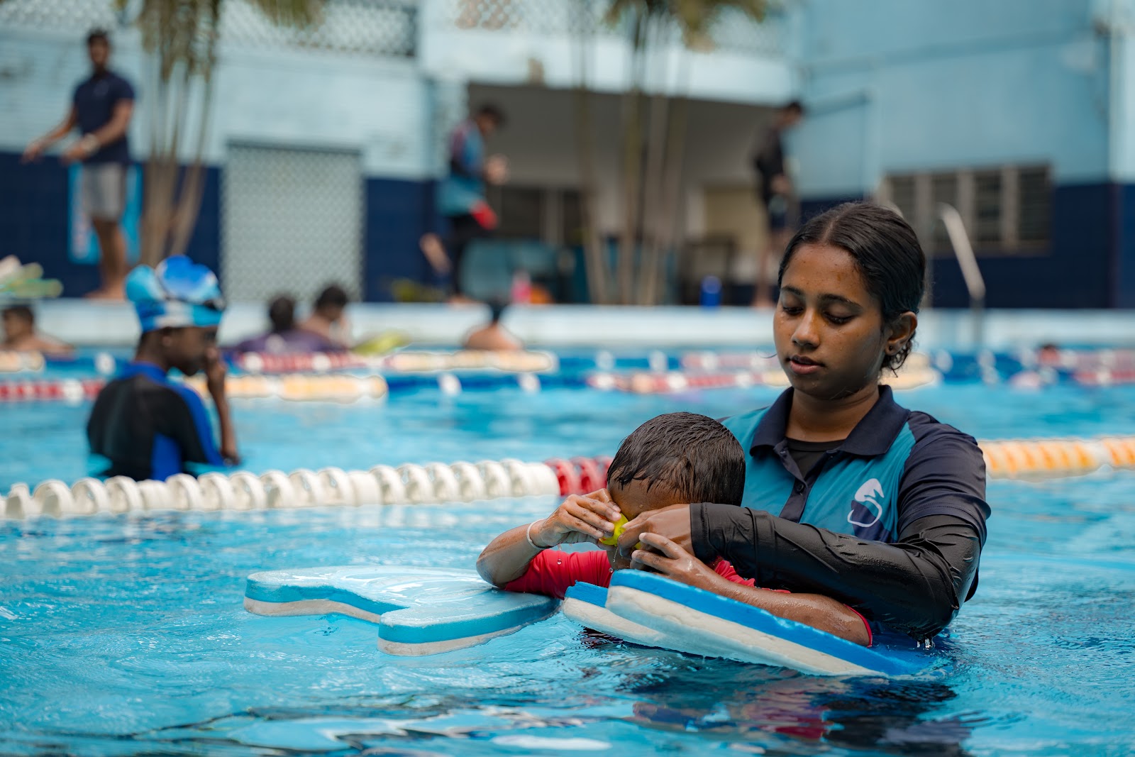 Expert coaches teaching in the pool