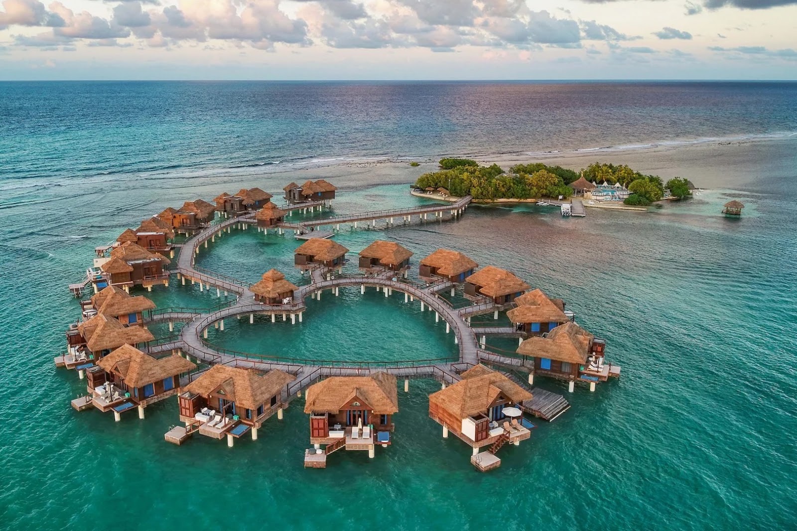 Overwater bungalow and private-island setting at the former Sandals Royal Caribbean in Jamaica, now being reimagined as Sandals Caribbean Cay.