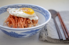 Chuẩn bị 1 phần cơm trắng. Chiên một quả trứng, cho salad củ cải và trứng lên trên tô cơm, rắc mè trắng rang nữa là thưởng thức nào. Món này làm siêu nhanh, ăn siêu ngon, bảo đảm bạn sẽ không bao giờ bị ngán đâu.