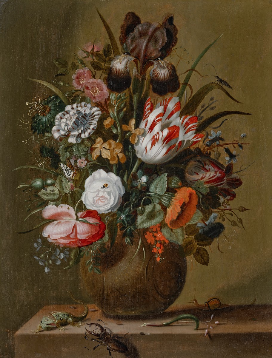 Roses tulips an iris and other flowers in a stoneware vase on a ledge with a liz