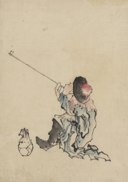 A traveler seated wearing a robe boots and rounded top conical hat smoking a lon