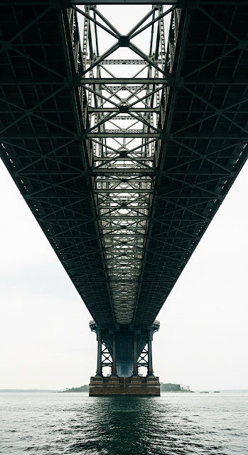 Dramatic Low Angle View Upwards Under Massive Steel Bridge Structure and Supports - Free mobile Wallpaper