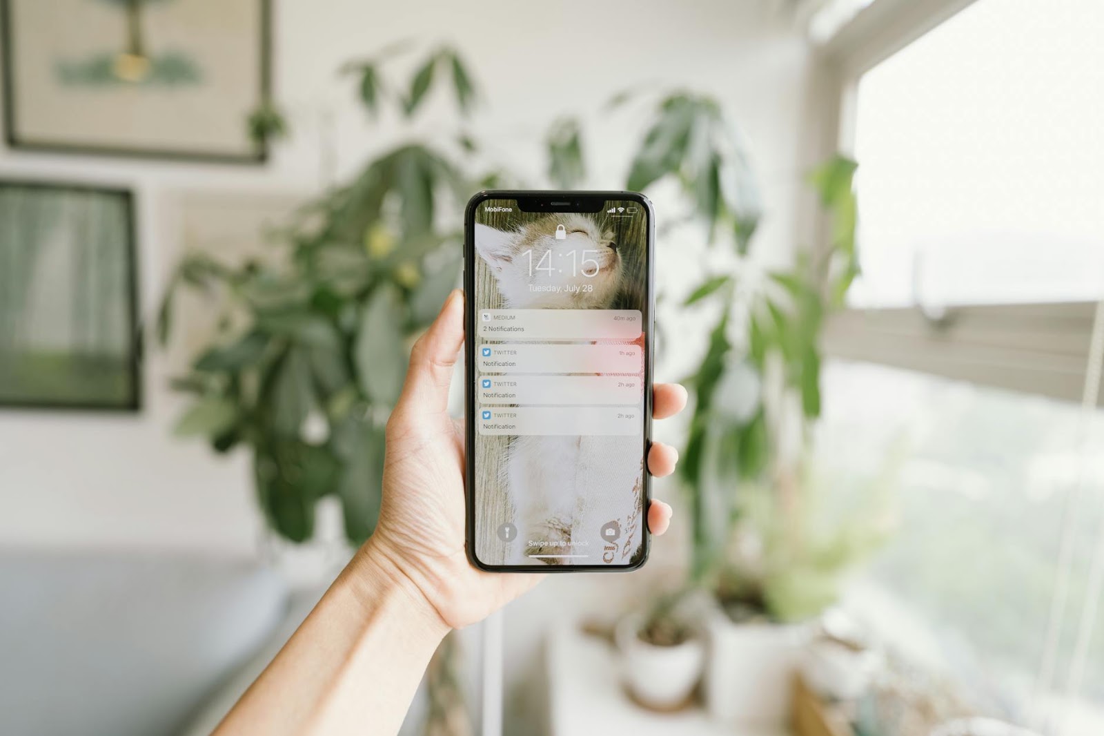 A smart water leak detector sending an alert to a smartphone, showing proactive smart home protection.