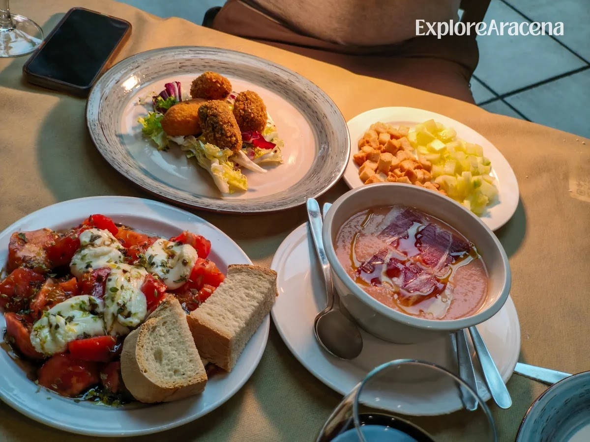 Summer starters at Brioso Restaurante, including chilled gazpacho topped with thinly sliced jamón, tomato and goat’s cheese salad, bread and golden croquettes.