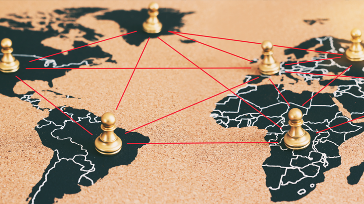 Pawn Pieces on top of a flat map of earth to illustrate geopolitics and green inflation