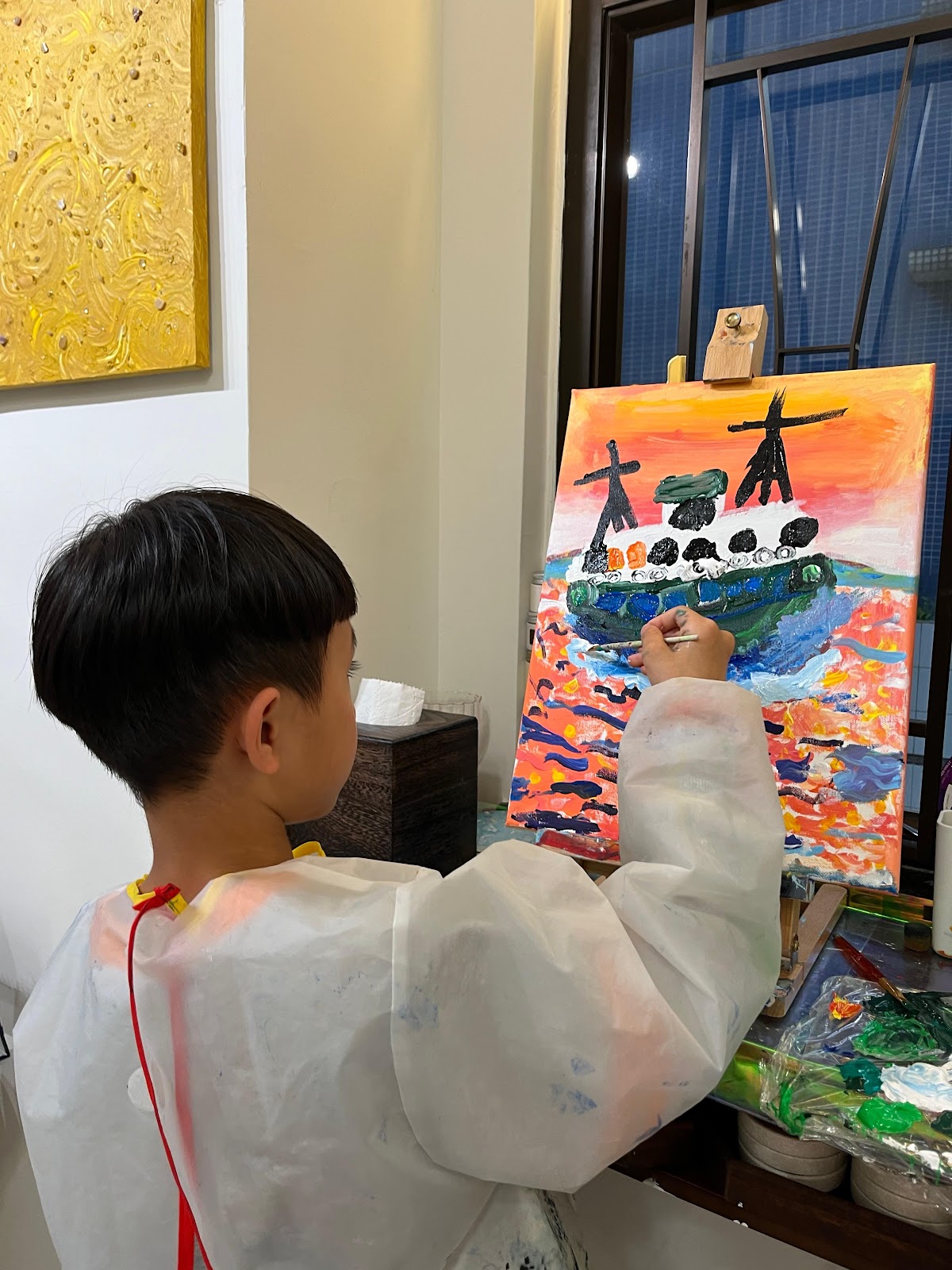 A child happily painting with watercolors.
