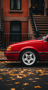 Close-Up of a Classic Red Car Parked by an Ornate Brownstone in Autumn