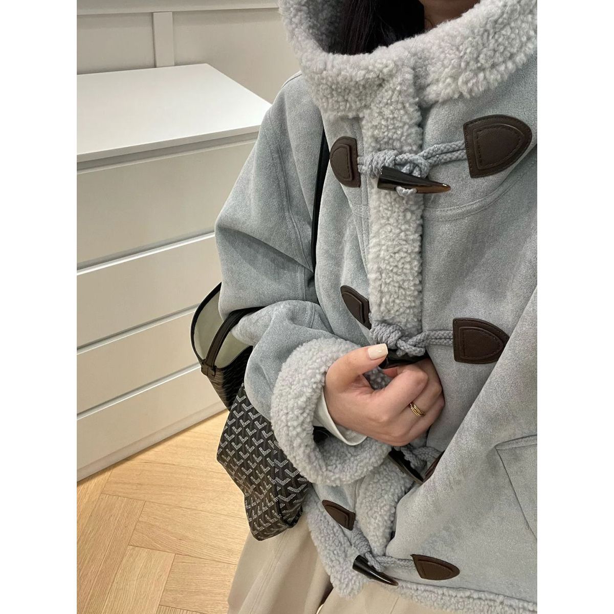 Modern hooded jacket made of lambskin imitation with toggle buttons
