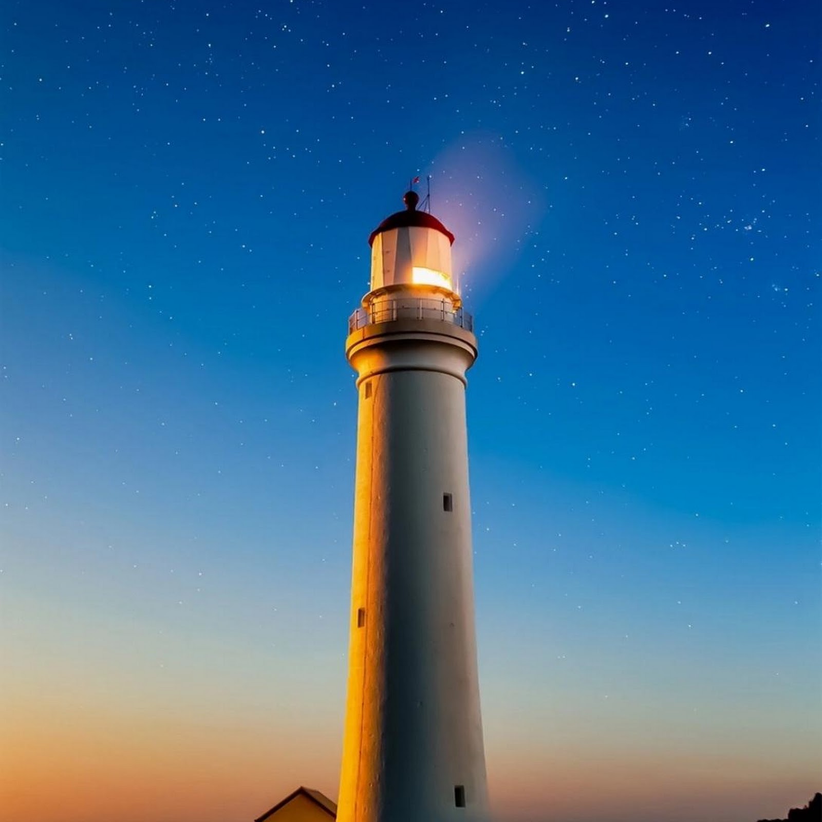 Download Tall White Lighthouse Under Stars Full HD iPhone