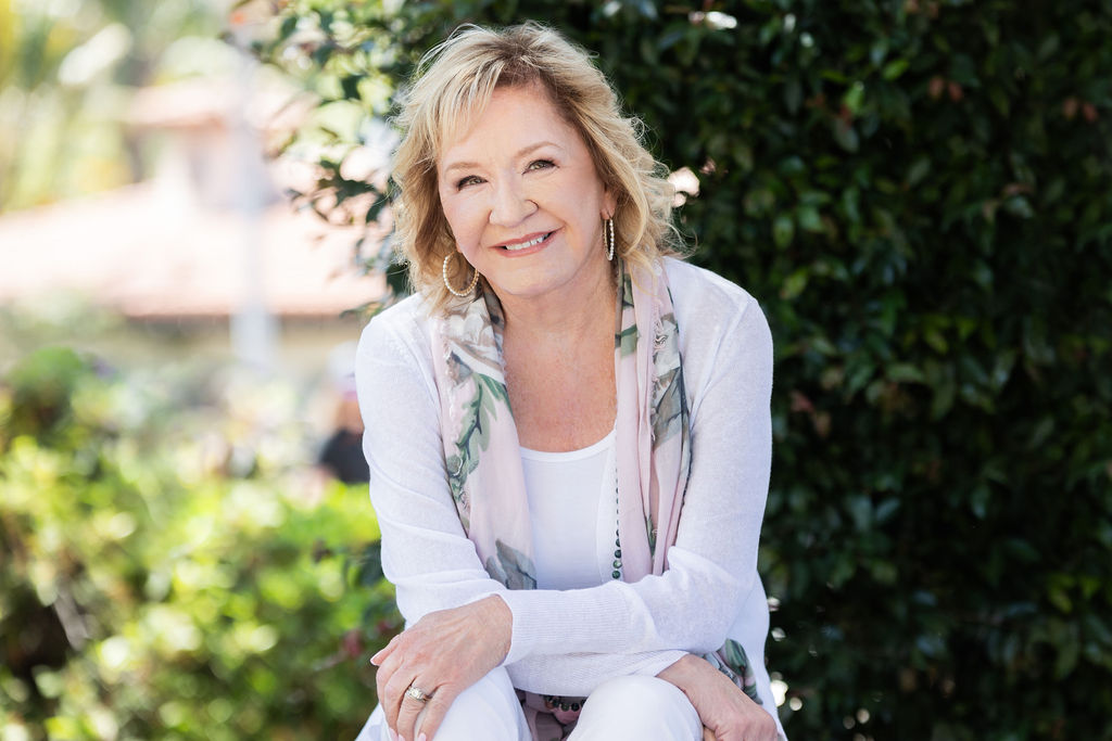 Deb Sheppard smiling in a sunlit garden