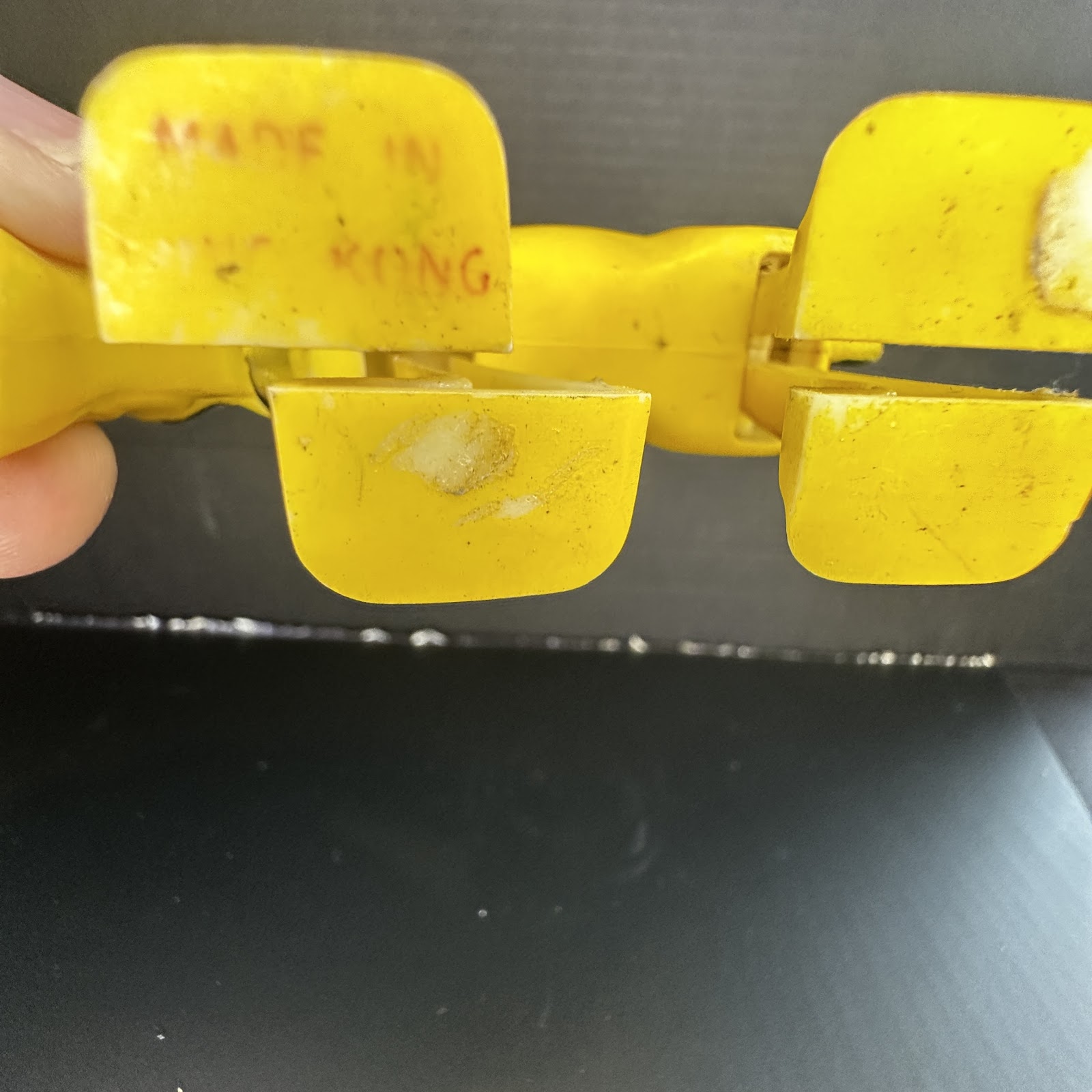 Yellow hard plastic Pluto figure in sniffing pose, vintage 1970s–80s Hong Kong manufacture, showing surface wear and patina consistent with age