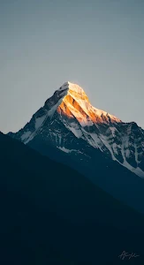 Golden Sunrise Light on Snow-Capped Himalayan Peak