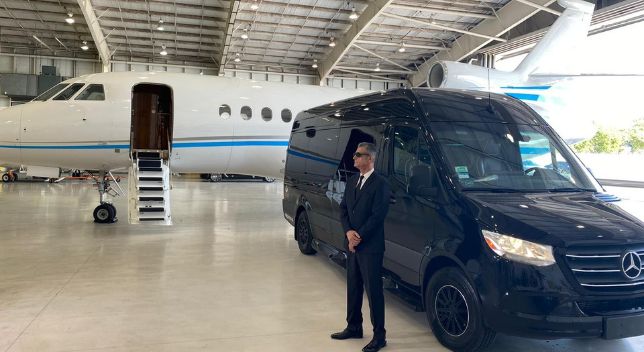 Executive vehicle staged on the ramp beside a business jet in Miami