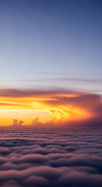 Towering Cumulus Clouds at Dusk Over a Distant City - Free mobile Wallpaper
