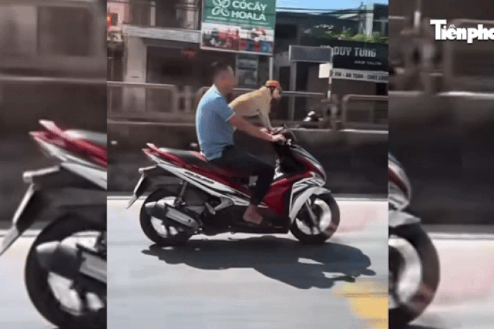 Người đầu trần chạy xe máy chở chó đội mũ bảo hiểm trên quốc lộ gây xôn xao - Báo Tiền Phong