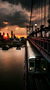 Train Crossing Suspension Bridge Dramatic Sunset Skyline