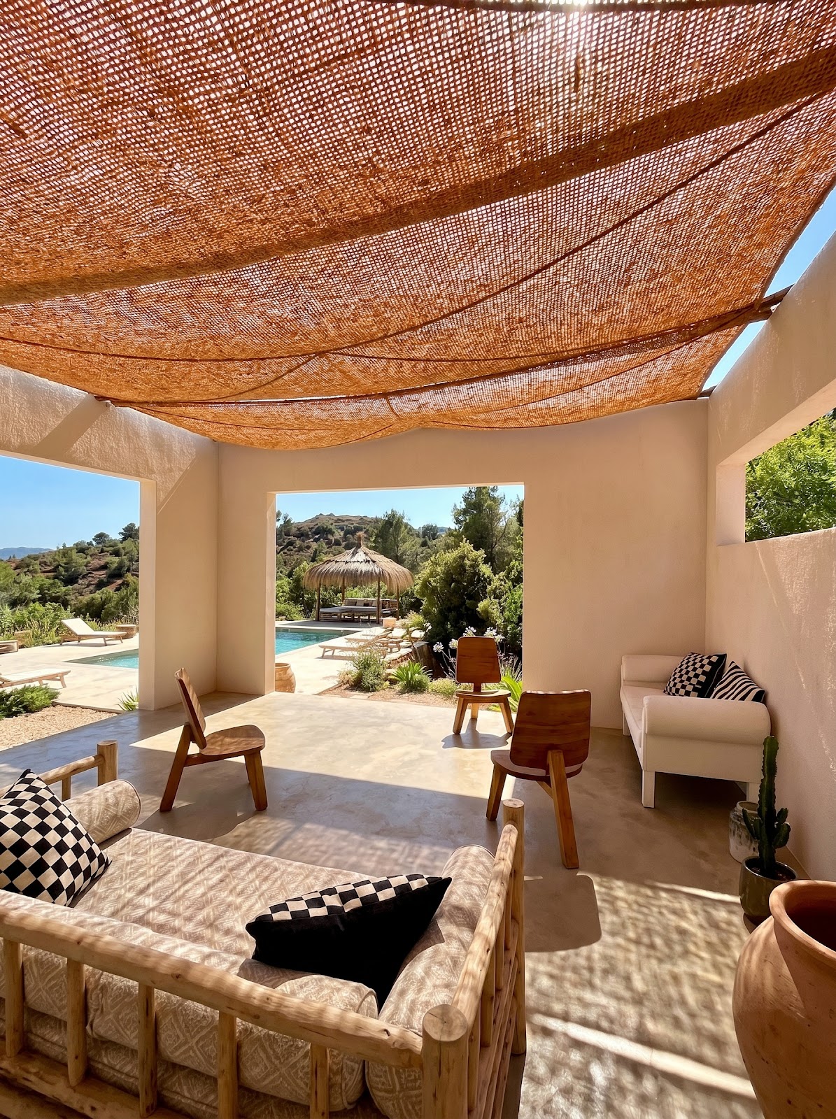 Natural coir shade sail over covered terrace with passive cooling airflow