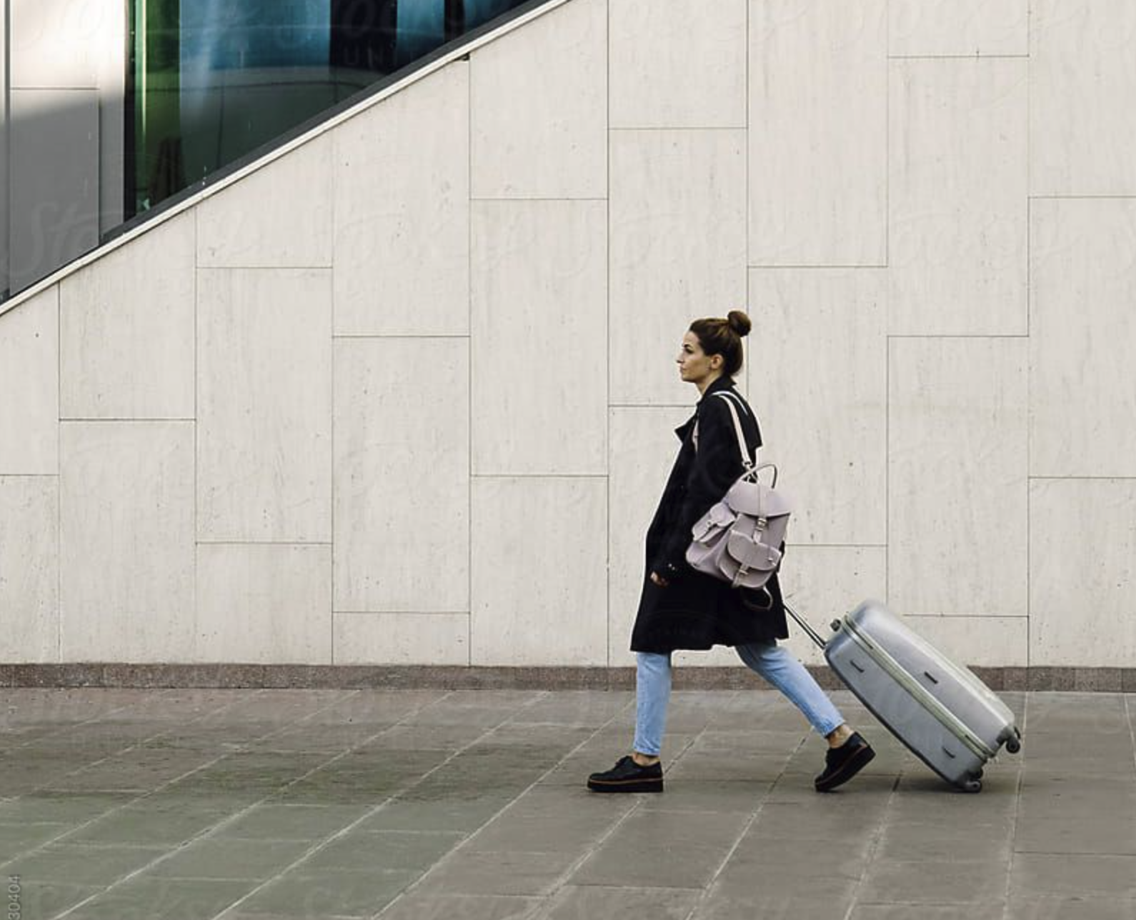 Woman walking with luggage in an airport
