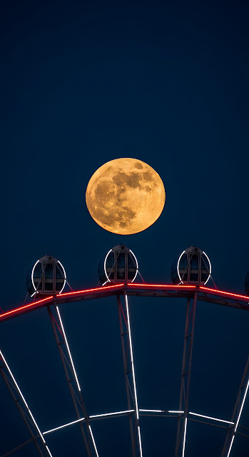 Dramatic Telephoto Shot of Giant Full Supermoon Rising Over a Modern, Red-Lit Observation Wheel - Free mobile Wallpaper