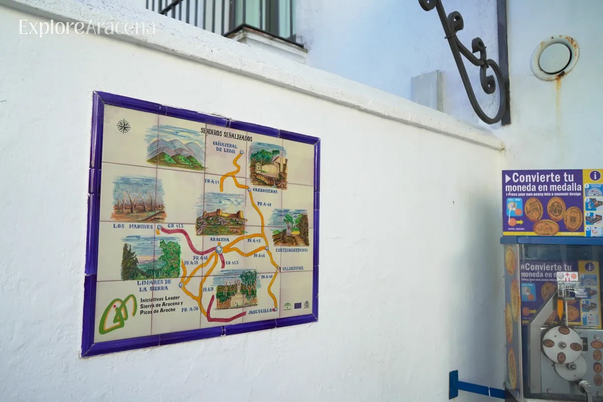 Decorative ceramic tile mural in Aracena illustrating hiking destinations and scenic routes around the Sierra.