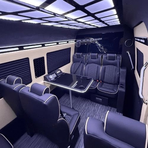 Leather captain seats and a conference table inside the Executive Sprinter