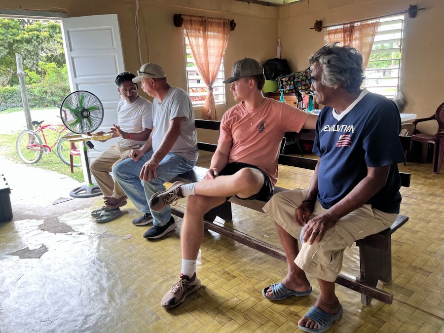 Don beside a man reading again — Belize