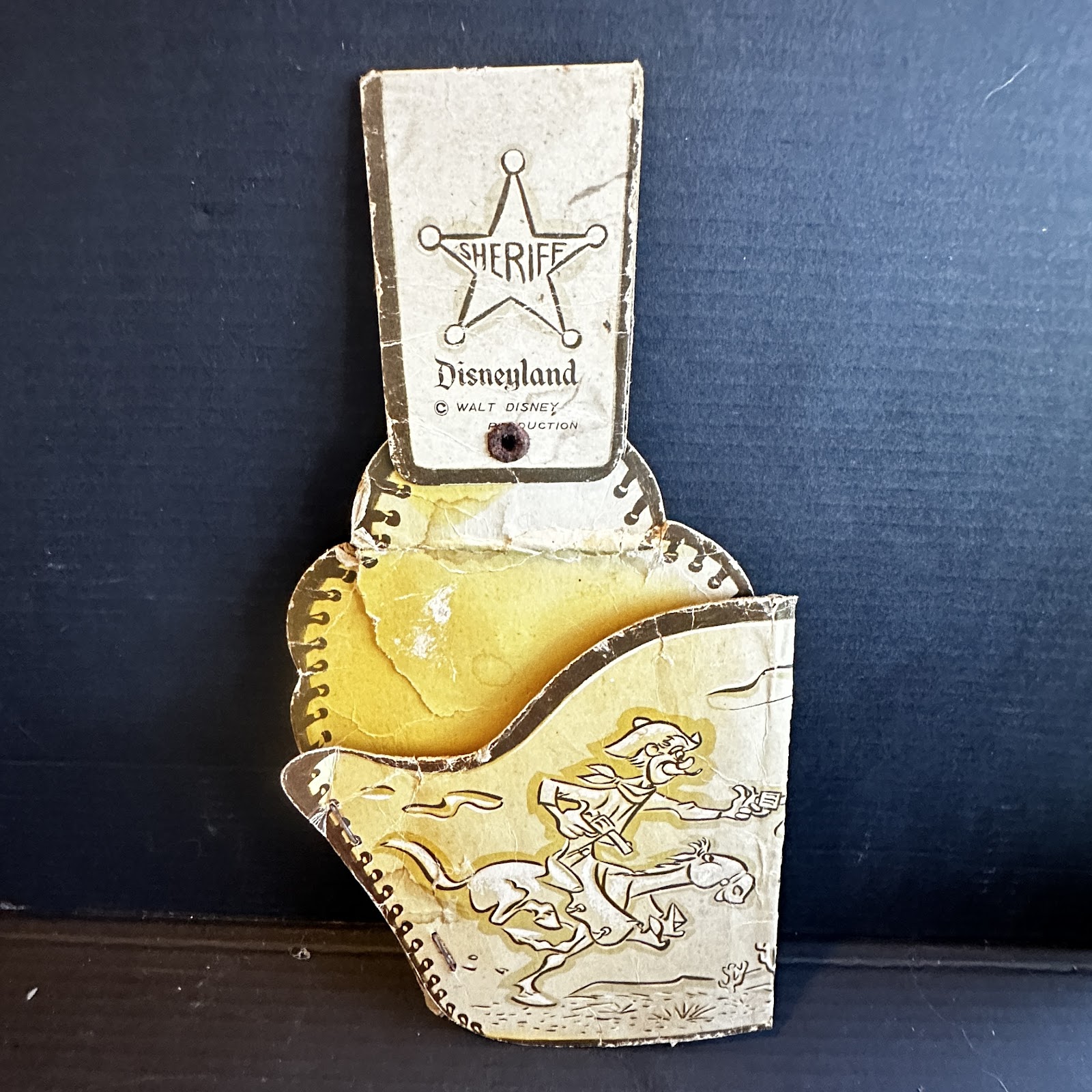 Vintage Frontierland toy holster or sheriff badge backing card featuring Goofy, approximately 8 by 4.5 inches, circa 1955–1965, showing age and fragility consistent with original Disneyland-era paper merchandise