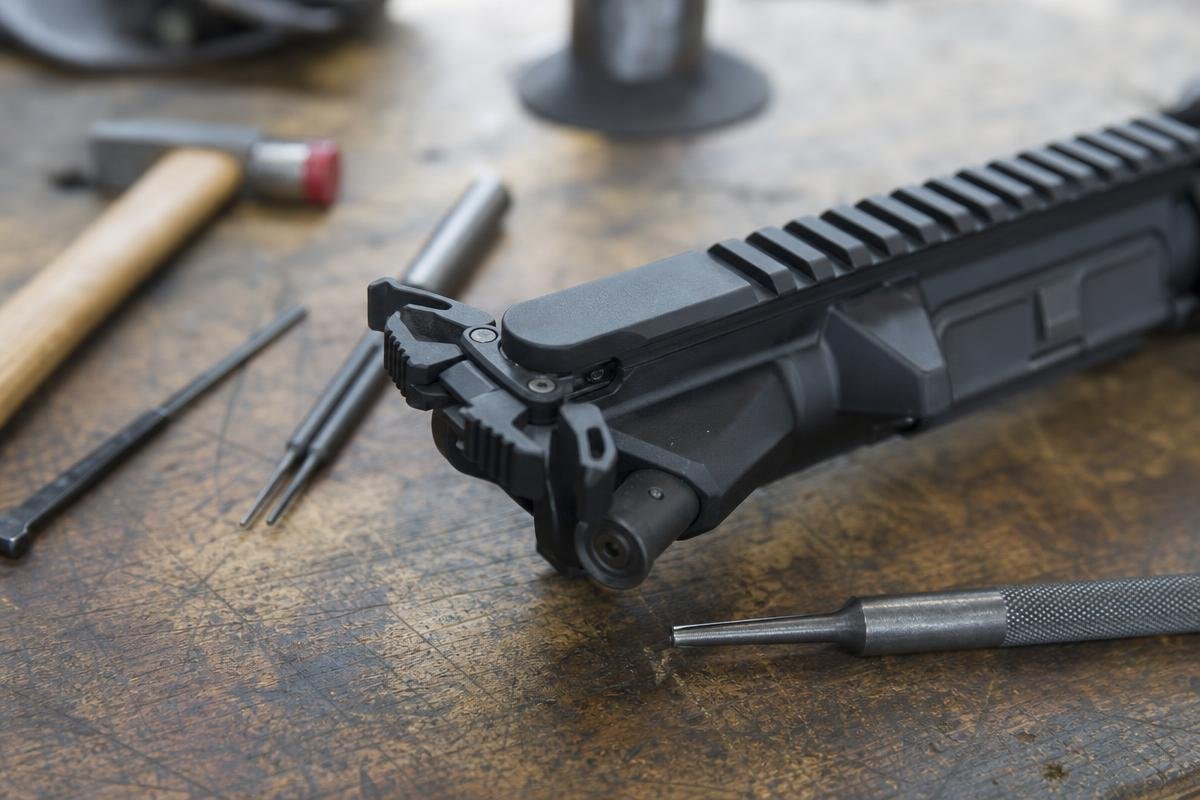 Extended-latch AR-15 charging handle seated in an upper receiver ready to charge