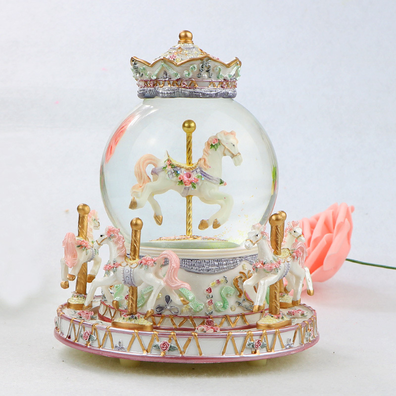 Decorative music box with snow globe and carousel