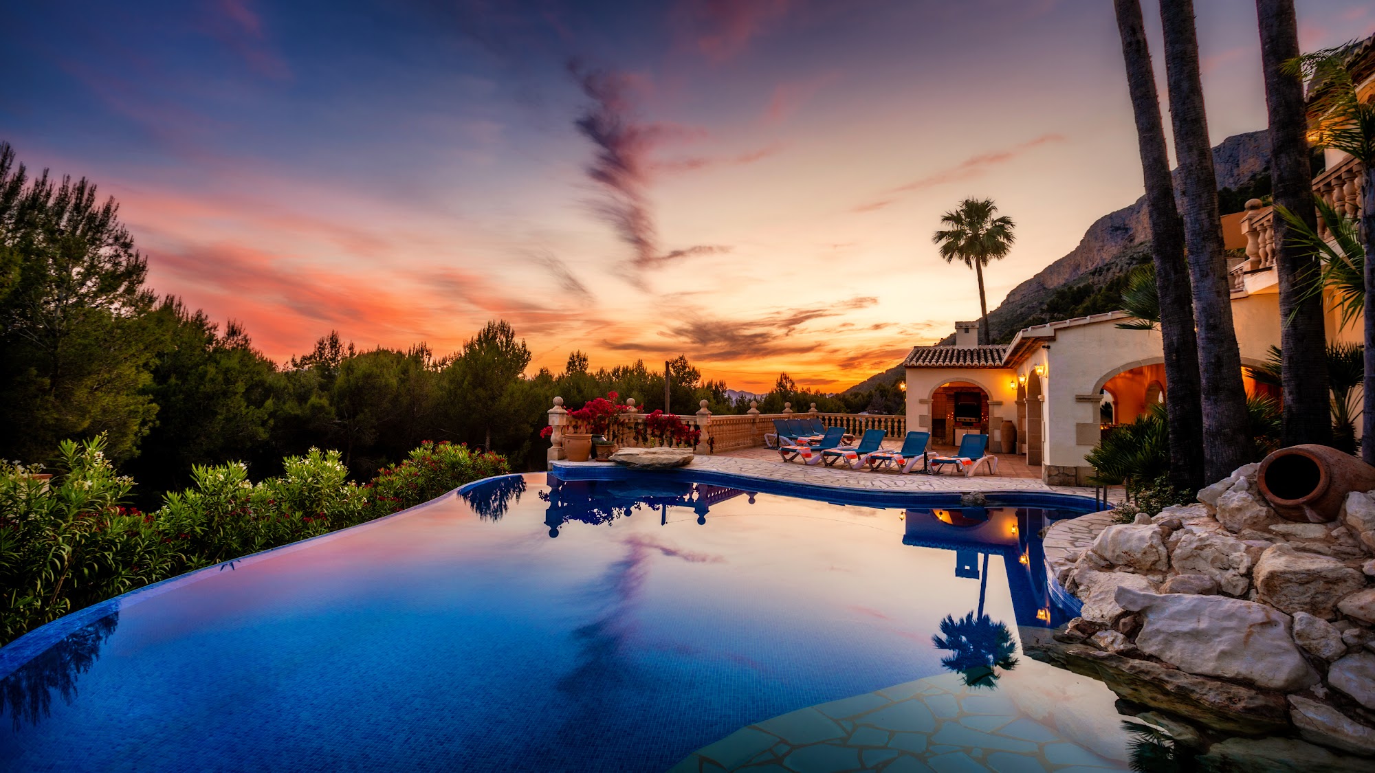 Pool reflecting a vivid sunset sky
