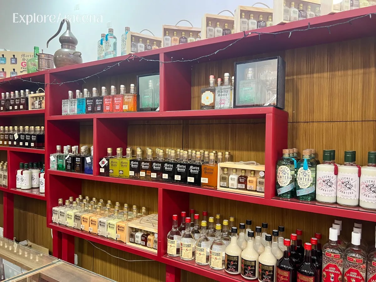 Bottle of Martes Santos Crema de Maracuyá displayed beside a window inside the historic distillery.