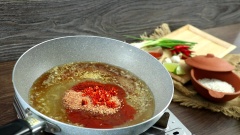 Làm sốt mắm ớt: Bắc chảo lên bếp, cho vào chảo 2 muỗng canh dầu ăn, chờ dầu nóng rồi phi thơm 10gr tỏi băm. Kế đến cho vào 50gr đường, 50ml nước mắm, 30ml nước cốt chanh, 30gr tương ớt, 30gr ớt sa tế, 20gr tôm khô (giã nhuyễn), 20gr ớt tươi và 10gr ớt bột. Đảo đều sốt đến khi sôi thì cho vào 50gr tóp mỡ, trộn đều lần nữa rồi tắt bếp.
